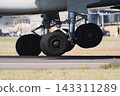 Airplane landing gear on runway 143311289