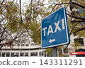 Taxi sign in city street 143311291
