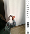 Children in pajamas enjoying shadow puppetry in the morning sunlight. 143311699