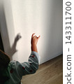 Children in pajamas enjoying shadow puppetry in the morning sunlight. 143311700