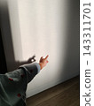 Children in pajamas enjoying shadow puppetry in the morning sunlight. 143311701