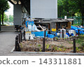 A makeshift shack and household goods located under an elevated railway. 143311881