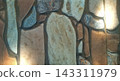 Beautiful background of a polished ceramic tile wall texture featuring an elegant abstract interlocking stone or mosaic pattern. The smooth surface showcases natural stone patterns in earth tones of b 143311979