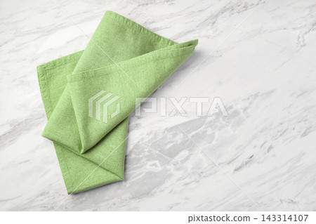 Green linen napkin on white marble kitchen table background, copy space Green linen napkin on white marble kitchen table background, copy space 143314107