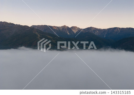 A sea of clouds and the Hakuba Three Peaks in the early morning, Hakuba Village, Nagano Prefecture (aerial photograph taken by drone) A sea of clouds and the Hakuba Three Peaks in the early morning, Hakuba Village, Nagano Prefecture (aerial photograph taken by drone) 143315185