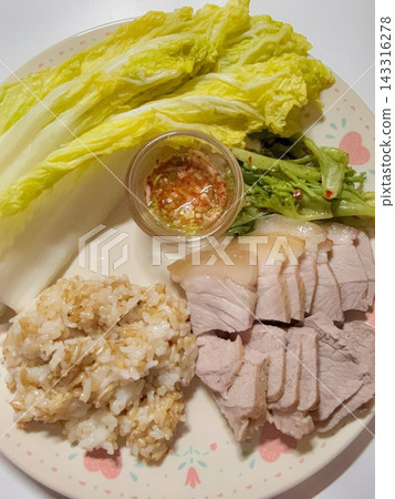 Suyuk, a traditional Korean dish of boiled pork slices, tender and juicy, often served with salted shrimp sauce, garlic, and ssamjang. Perfect for wrapping in lettuce for a flavorful, balanced bite. 143316278