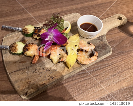Hawaiian-style plate of grilled shrimp and vegetables on skewers Hawaiian-style plate of grilled shrimp and vegetables on skewers 143318019