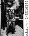 Drunk Smoker Surrounded by Cigarette Smoke on Toilet 143319349