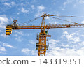 Yellow Tower Crane Against Blue Sky Construction Scene 143319351