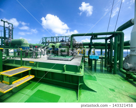 Maritime chemical transportation concept displaying complex green piping installation at sunny day Maritime chemical transportation concept displaying complex green piping installation at sunny day 143321458