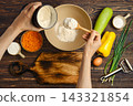 Top view of hands pour flour into bowl 143321854