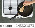 Home cooking vegetable fritters being prepared on stove in kitchen 143321873