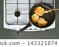 Home cooking vegetable fritters on stove in kitchen at home 143321874