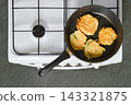 Home cooking vegetable fritters on stove in kitchen 143321875