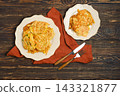 Home cooking vegetable fritters served on plates with cutlery on wooden table 143321877