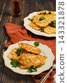 Home cooking vegetable fritters served on plates with garnishes 143321878
