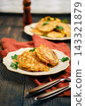 Home cooking vegetable fritters on a plate with herbs in a kitchen setting 143321879