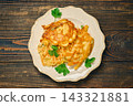 Home cooking vegetable fritters on plate with herbs displayed on wooden table 143321881