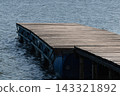 Wooden floating pier on calm water 143321892