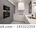 Modern kitchen with gray cabinets, white countertops, and patterned floor tiles. Features built-in oven and sink. Bright and minimalist design. 143322359