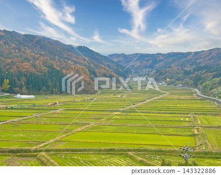 A rural landscape and foothills enveloped in blue skies and autumn mountains. A rural landscape and foothills enveloped in blue skies and autumn mountains. 143322886