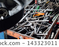 Assorted mechanic tools are ready for use in a full metal toolbox 143323011