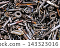 Rusty metal bolts and screws creating industrial background 143323016