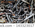 Rusty metal bolts and screws creating industrial background 143323017