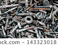 Rusty metal bolts and screws creating industrial background 143323018