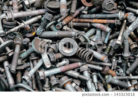Rusty metal bolts and screws creating industrial background Rusty metal bolts and screws creating industrial background 143323018