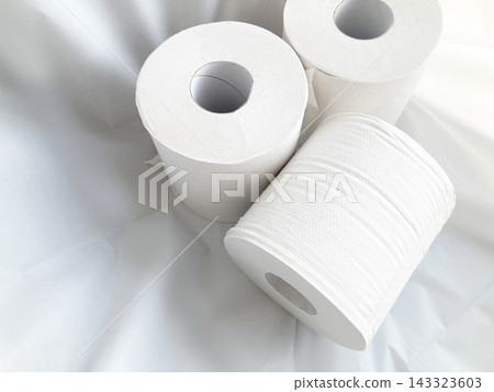 Images of multiple toilet paper rolls placed against a white cloth background, representing everyday necessities and disaster preparedness supplies. Images of multiple toilet paper rolls placed against a white cloth background, representing everyday necessities and disaster preparedness supplies. 143323603