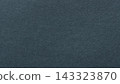 Dark blue-gray paper texture background with dense fine fibers across a rough matte surface 143323870