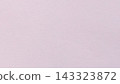 Pale pink paper texture background with fine grain and subtle mottling across a blank matte surface 143323872