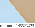 Tan and light blue paper texture background with a diagonal edge between overlapping sheets and fine grain 143323875