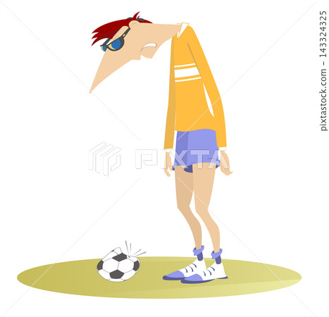 Funny situation on the soccer field. Puzzled football player stands near a broken ball. Man playing soccer. Upset football player and a deflated ball Funny situation on the soccer field. Puzzled football player stands near a broken ball. Man playing soccer. Upset football player and a deflated ball 143324325