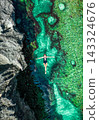 Aerial top view of a girl lying in the water on rocky the Angels Billabong in Nusa Penida island 143324676
