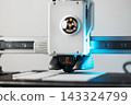 3D printer head printing a detailed white plastic component 143324799