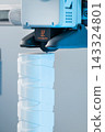 3D printer head printing a detailed white plastic component 143324801
