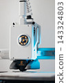 Extreme macro shot of 3D printer nozzle printing white plastic object 143324803