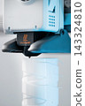 3D printer head printing a detailed white plastic component 143324810