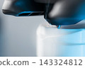 Extreme macro shot of 3D printer nozzle printing white plastic object 143324812