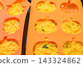 Pumpkin cake made by pouring batter into a silicone mold. 143324862