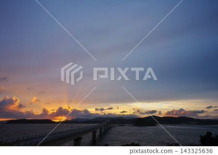View of the sunrise over Tsunoshima Bridge from Sezaki Yo Park on Tsunoshima Island. View of the sunrise over Tsunoshima Bridge from Sezaki Yo Park on Tsunoshima Island. 143325636