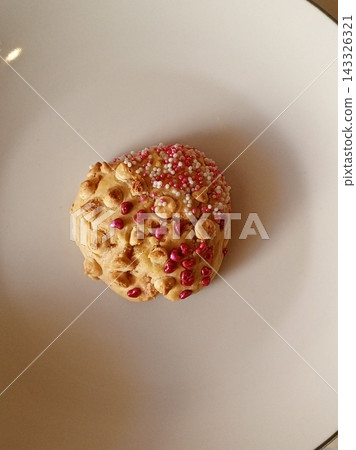 Freshly baked cookies with a golden-brown finish and chocolate chips. Perfectly crisp on the edges with a soft center, offering a delicious, comforting treat for any occasion. 143326321