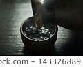 Pour hot sake into the glass. 143326889