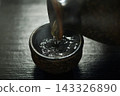 Pour hot sake into the glass. 143326890
