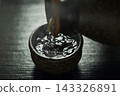 Pour hot sake into the glass. 143326891
