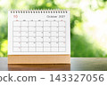 October 2027 Calendar desk for organizer to plan and reminder on wooden table. 143327056