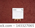 January 2027 calendar on red crumpled paper background. Directly above. 143327065