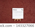 February 2027 calendar on red crumpled paper background. Directly above. 143327066